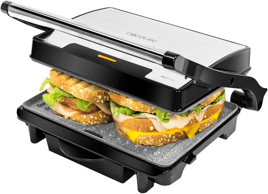 Parrilla eléctrica Cecotec Rock'nGrill 1500 Rapid con dos sándwiches mixtos tostándose entre sus placas de piedra