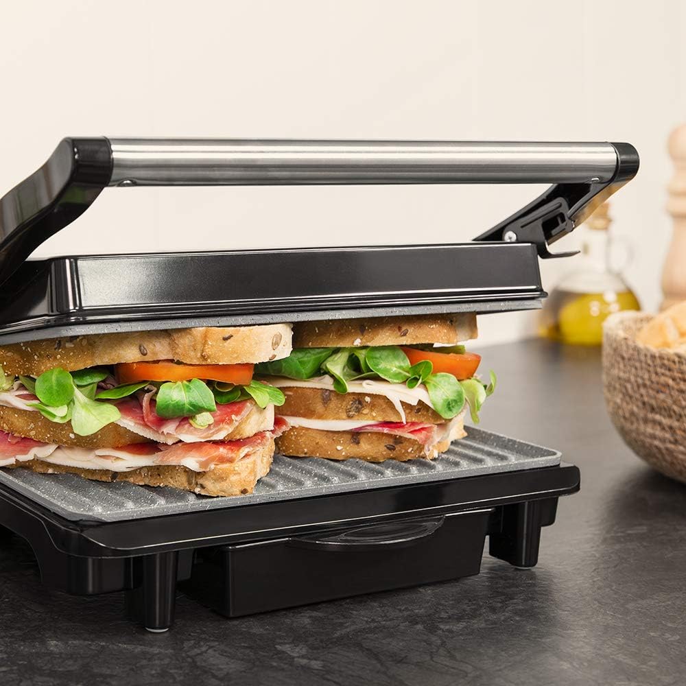 Placa superior flotante de la Cecotec Rock'nGrill 1500 Rapid adaptándose a un sándwich alto relleno de jamón y lechuga